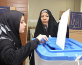 امراة عراقية تضع ورقة الاقتراع بالصندوق